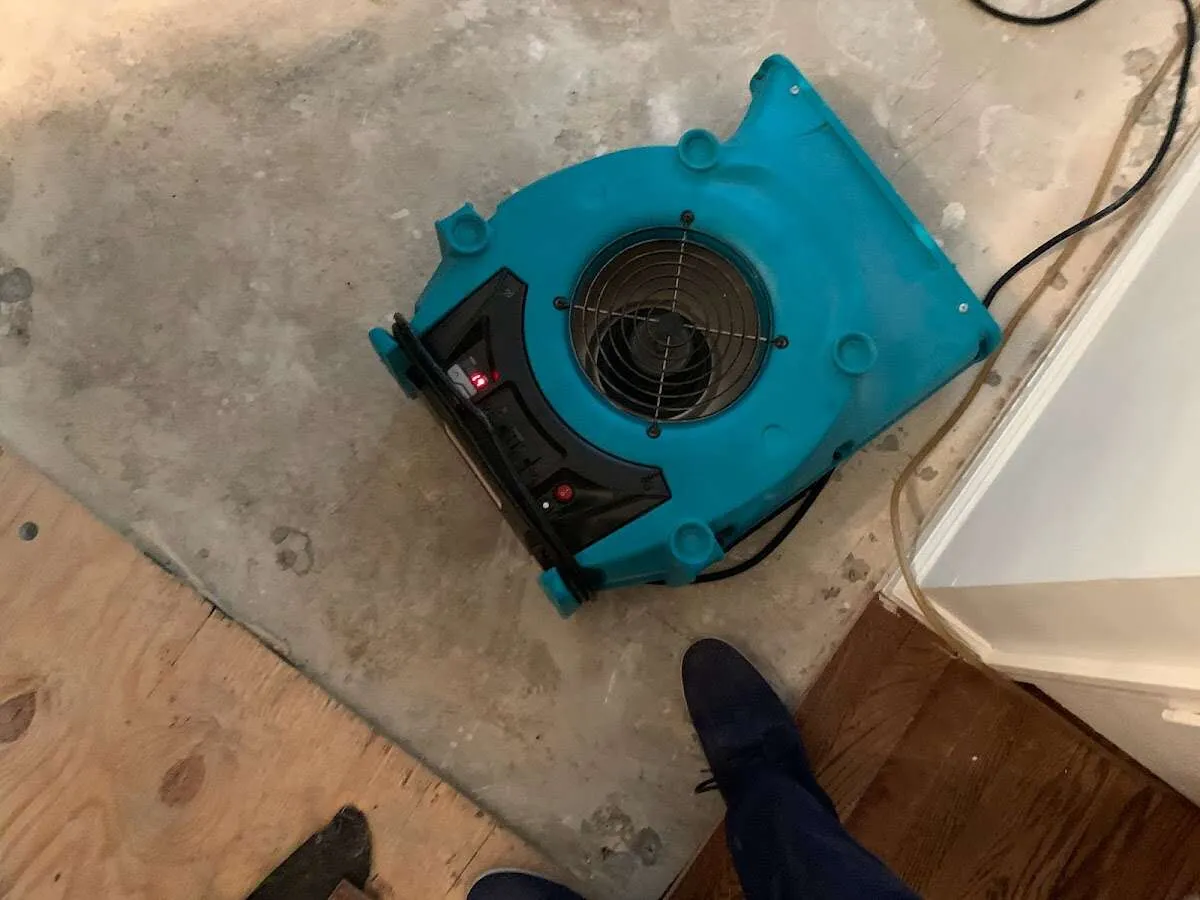 Air mover drying subfloor during Commercial Water Damage Restoration in Belvidere